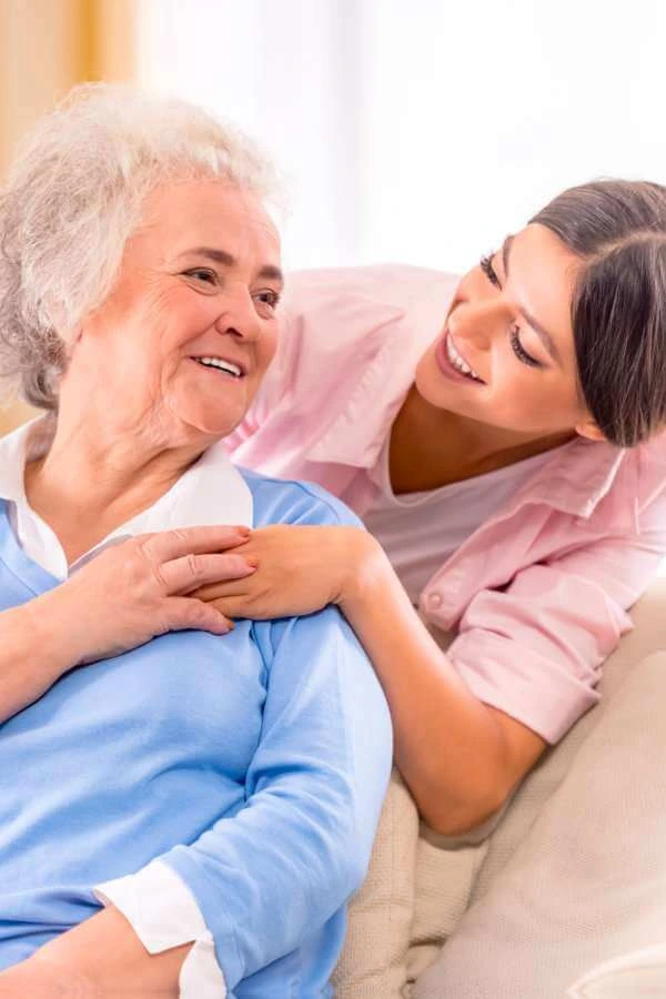 A female and an elderly woman sitting on a sofa